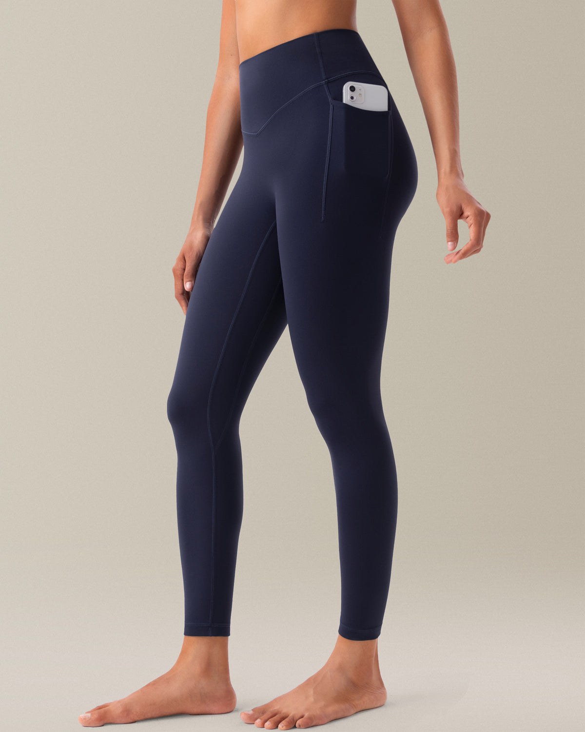 YUNOGA HugMotion women's high-waisted leggings in navy blazer, featuring no front seam design and side pockets.