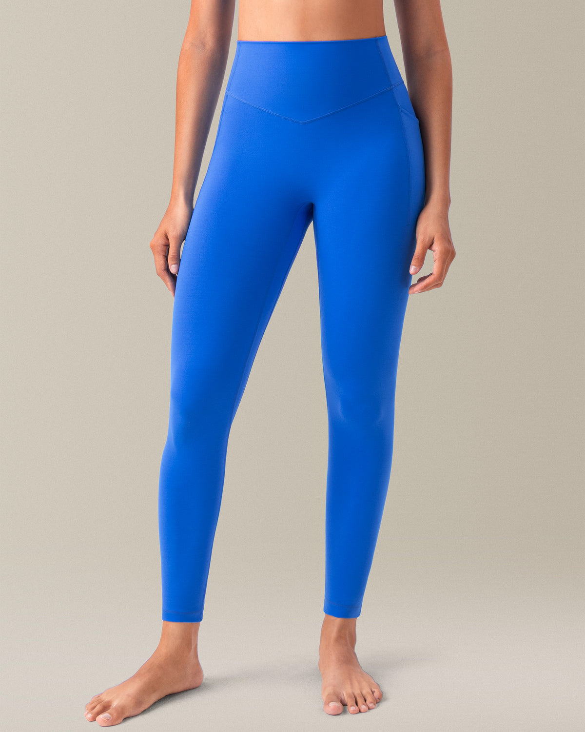 YUNOGA HugMotion women's high-waisted leggings in Princess Blue, featuring no front seam design and side pockets.