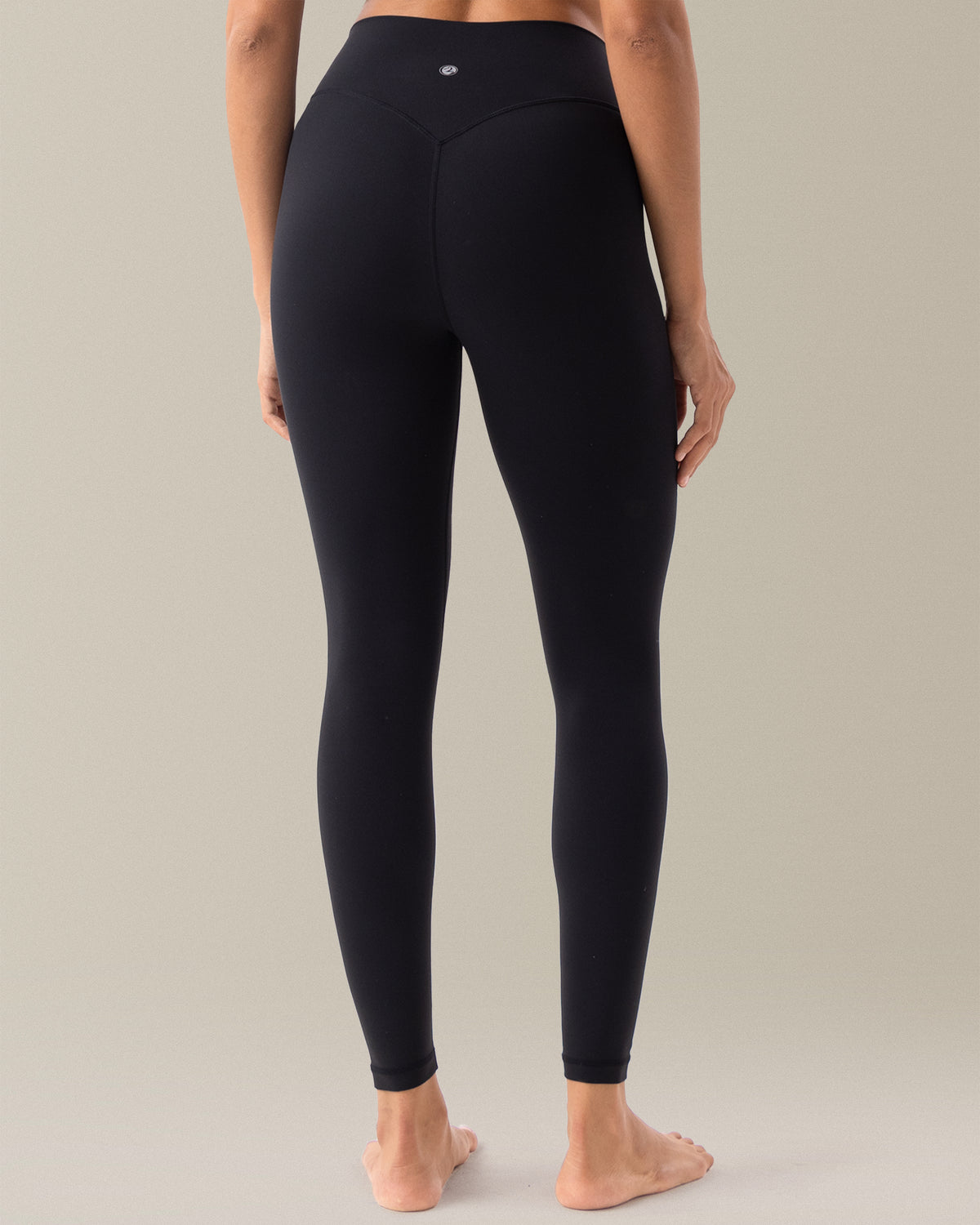 YUNOGA HugMotion Women's 25" No Front Seam Leggings in black, highlighting V-shaped waistband and seamless back